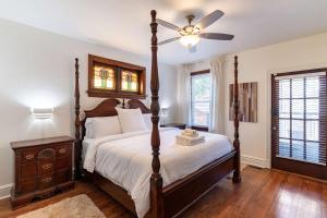 a bedroom with a bed and a ceiling fan at Historic 2BR with Deck Games & Garage in Saint Louis