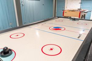 a basketball court with red circles on the floor at Historic 2BR with Deck Games & Garage in Saint Louis