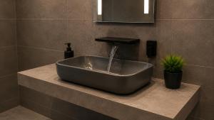 a sink in a bathroom with a faucet at Köln Pulheim Wellness Oase in Pulheim +16 photos