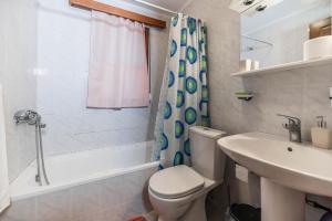 a bathroom with a toilet and a sink and a shower at Villa Hara Kiotari in Gennadi