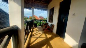 a balcony of a house with a view of the mountains at Raphy Home in Nungwi