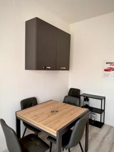 a dining room with a wooden table and chairs at We4 apartment Maranello in Maranello +5 photos
