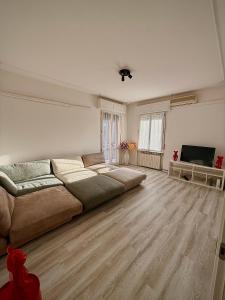 a living room with a large bed and a television at We4 apartment Maranello in Maranello