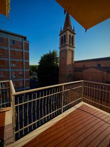 a balcony with a clock tower on a building at We4 apartment Maranello in Maranello