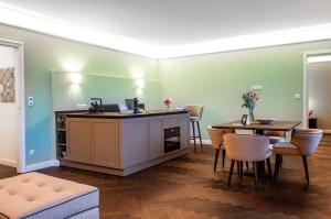 a living room with a table and a dining room at Bartl Apartments in Rottach-Egern +7 photos