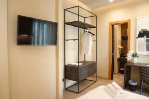 a room with a closet with a television on a wall at Notos Home in Bitonto