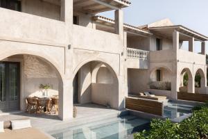 a house with a swimming pool and a patio at Casa di Pierro in Lithakia