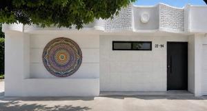a white building with a mandala on the side of it at Habitaciónes Entradas Privadas independientes tipo APTO in Valledupar