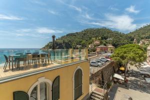a building with a balcony with a view of the ocean at SeaFrontBonassola in Bonassola