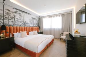 a hotel room with a large bed and a chair at Occidental Casablanca Medina in Casablanca