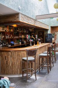 a wooden bar with chairs at a restaurant at Northover Manor Hotel in Ilchester