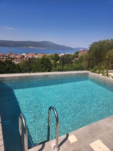 a swimming pool with a view of the water at Apartman Bloom 6 in Tivat