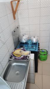 a kitchen with two pots on top of a stove at ELIEL Guesthouse in Parakou