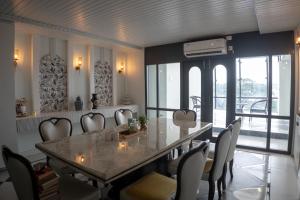 a dining room with a large table and chairs at Divine View- Boutique Stay in Guwahati