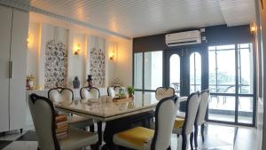 a dining room with a table and chairs at Divine View- Boutique Stay in Guwahati +67 photos