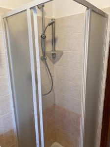 a shower with a glass door in a bathroom at Casetta in Centro in San Salvo