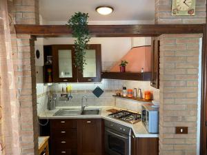 a kitchen with a sink and a stove at Casetta in Centro in San Salvo