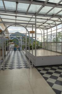 a metal covered walkway on a building with a checkered floor at Divine View- Boutique Stay in Guwahati