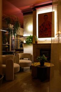a lobby with a fireplace and a painting of a man at Dworek in Kolbuszowa