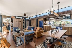 a living room with a couch and a table at Mod West Ranch: 5-acre Boulder Playground in Pioneertown