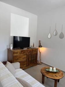 a living room with a couch and a table at Sykano Espace, Skyros Island in Skiros
