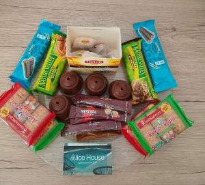 a pile of different types of snacks and donuts at Alice House 1 in Amarynthos
