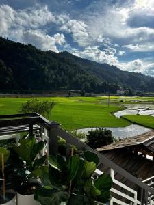 a view of a golf course from the balcony of a house at Chải Eco House in Mù Cang Chải +38 photos