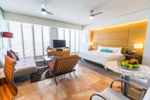 a hotel room with a bed and a table with a bowl of fruit at Palacio Mundo Imperial Riviera Diamante Acapulco in Acapulco