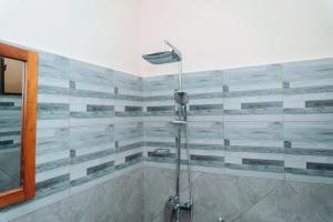 a shower with a glass door in a bathroom at Arusha Giraffe Lodge in Arusha +65 photos