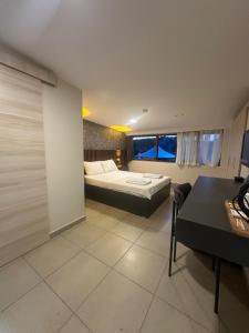 a bedroom with a bed and a desk in a room at Mad Sea Beach Hotel in Şile