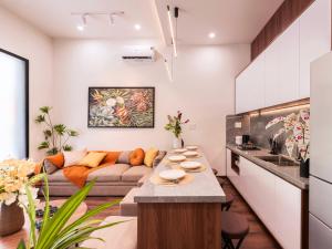 a living room with a couch and a table at Gon De Home Ham Nghi in Ho Chi Minh City +28 photos