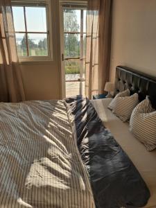 a bedroom with two beds and a window at Sjöutsikt med bastu som tillval in Tällberg