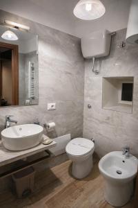 a bathroom with a sink and a toilet and a mirror at Da Nonna Iolanda in Caiazzo