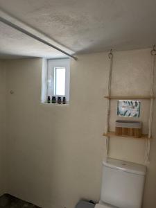 a bathroom with a toilet and a window at Sykano Espace, Skyros Island in Skiros +21 photos