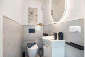 a small bathroom with a sink and a toilet at Panoramablick am Steinhuder Meer in Steinhude +31 photos