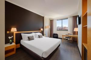 a hotel room with a large bed and a window at City Life Hotel Poliziano, by R Collection Hotels in Milan