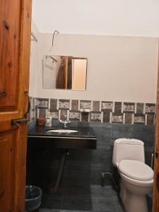 a bathroom with a toilet and a sink at Sunset View Luxury Apartments in Nathia Gali +28 photos