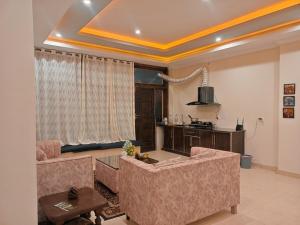 a living room with a couch and a table at Sunset View Luxury Apartments in Nathia Gali