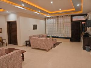 a living room with a couch and a tv at Sunset View Luxury Apartments in Nathia Gali