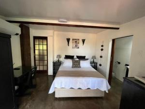 a bedroom with a large bed and a mirror at Kimba Lodge and Tours in Phalaborwa +68 photos