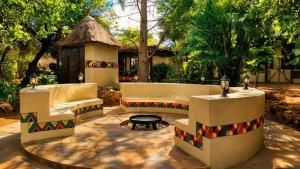 a patio with a couch and a gazebo at Kimba Lodge and Tours in Phalaborwa