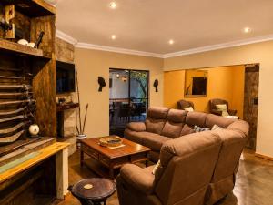 a living room with a couch and a table at Kimba Lodge and Tours in Phalaborwa