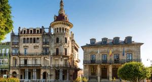 an old building with a tower on top of it at Apartamentos Dacosta in Ribadeo