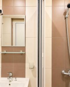 a bathroom with a shower and a sink and a mirror at KITA - Rooms with Sea View in Sveti Vlas