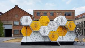 a pile of yellow and white objects in front of a building at Slaaptrailer MXGP Arnhem in Arnhem