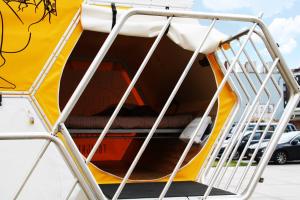an open door of a yellow and white trailer with a ladder at Slaaptrailer MXGP Arnhem in Arnhem