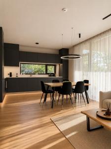 a kitchen and dining room with a table and chairs at Green Guest House in Sigulda