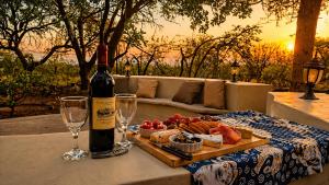 a bottle of wine and a tray of food on a table at Kimba Lodge and Tours in Phalaborwa