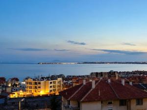 a view of a city with buildings and the water at KITA - Rooms with Sea View in Sveti Vlas