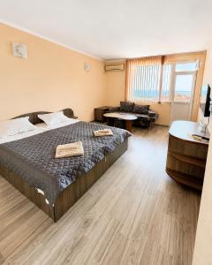 a bedroom with a bed and a living room at KITA - Rooms with Sea View in Sveti Vlas
